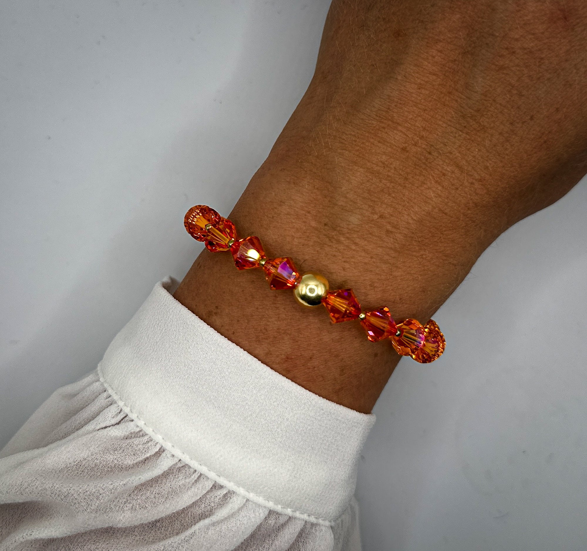 Armband aus orange-pinken Swarovski-Kristallperlen und vergoldeter 925-er Sterlingsilberkugel